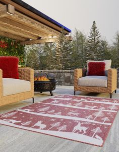 two chairs and a fire place on a patio with an outdoor fireplace in the background