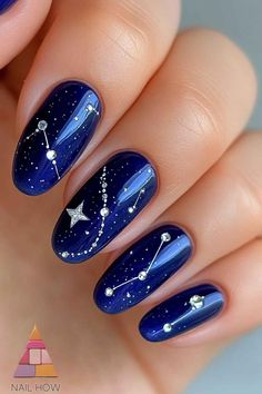 Reach for the stars! Navy blue nails with constellations and silver details are pure January magic. These celestial designs are perfect for winter nights. Find more January nails ideas at nailhow.com 💫