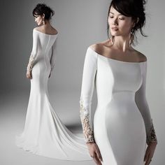 a woman in a white dress with long sleeves and an off the shoulder design on her body