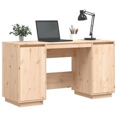 a laptop computer sitting on top of a wooden desk next to a potted plant