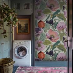 a washer and dryer in a room with floral wallpaper on the walls