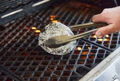 someone is grilling something on the grill with tongs and some sort of food