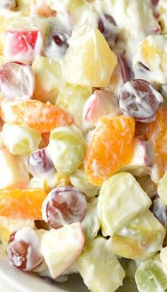 the fruit salad is made with oranges, grapes, and other fruits in it