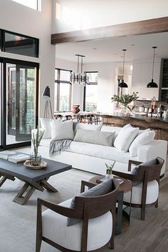 a living room filled with furniture and lots of windows