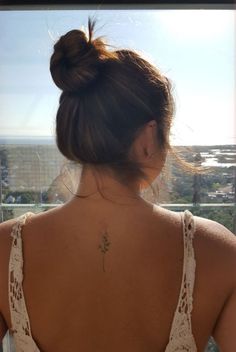 a woman with a flower tattoo on her back