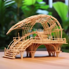 a wooden structure made out of bamboo sitting on top of a table