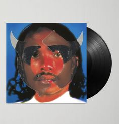 a black vinyl album with an image of a man's face and horns on it