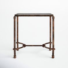 an iron and glass side table with two legs on one end, against a white background