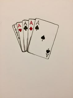 four playing cards are shown on a white surface with red and black ink, in the shape of spades