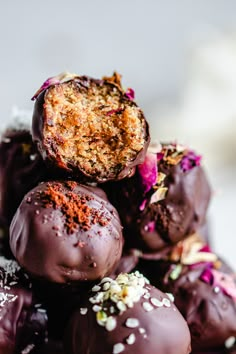 a pile of chocolate covered donuts sitting on top of each other