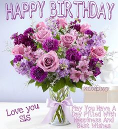 a vase filled with purple flowers on top of a table next to a card that says happy birthday