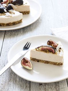 two slices of cheesecake with figs on the side