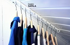 clothes hanging on hooks in front of a sign that says gildelt samla