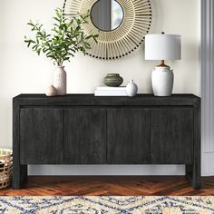 a living room with a large mirror on the wall next to a dresser and vases