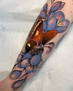 a person with a butterfly tattoo on their arm