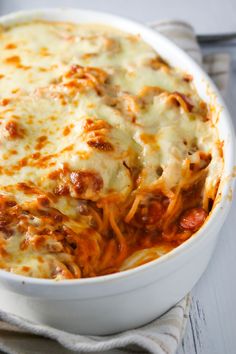 a casserole dish with cheese and meat in it