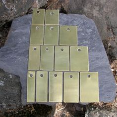 several metal tags are placed on a rock