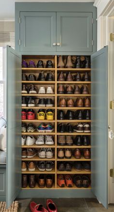 an organized closet with wooden shelves and shoes