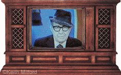 an old man wearing glasses and a fedora is on the television screen with his hand in his pocket