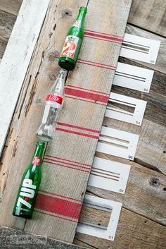 two empty soda bottles sitting on top of a wooden table