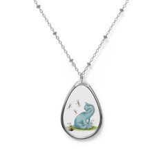 a necklace with an elephant and butterflies on the front, hanging from a silver chain