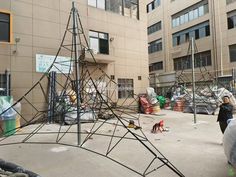 a group of people standing in front of a building with scaffolding on it