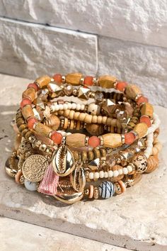 Accessorize your everyday outfit or occasion wear with this 10-Piece Boho Mixed Wood Bracelet Set. This set of shell charms with a unique wood stretch bracelets makes a beautiful addition to your accessory collection. It includes varying shapes and sizes for edgy mixed flair you're sure to love. These fashion bracelets sport a stretch-band construction to offer a perfect fit around your wrist. Plus, they can be worn separately or together with a variety of casual or dressy looks. Pair them with Stretch Beaded Bracelets Diy, White Beaded Bracelet, White Beads Bracelet, Bracelets Handmade Diy, Memorial Bracelet, Wood Bracelet, Beaded Bracelets Diy, Walk Out, Heishi Beads