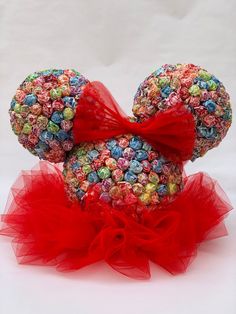 a mickey mouse made out of candy with a red bow