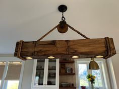 a wooden beam hanging from the ceiling in a kitchen