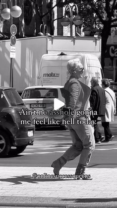 a man walking across a street next to traffic