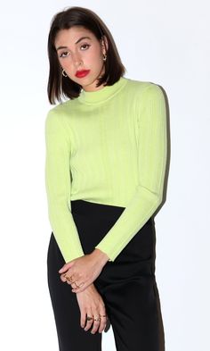 This lime green knit sweater features a high mock neck. Style it to your liking with any complementary colors or your favorite outerwear. Ribbed mock neck Fitted Long sleeves Turtleneck Self: 98% Polyester, 2% Spandex Length: 23 3/4" Chest: 13" Hand wash in cold water. Lay flat to dry. Model is wearing a size small Style #: G2210WT5825 Green Ribbed Sweater For Work, Green Ribbed Sweater For Workwear, Ribbed Green Sweater For Work, Spring Knit Turtleneck Top, Spring Knit Mock Neck Turtleneck Top, Green High Neck Sweater With Stretch, Green Stretch High Neck Sweater, Green High Neck Stretch Sweater, Green Textured Knit Sweater For Work