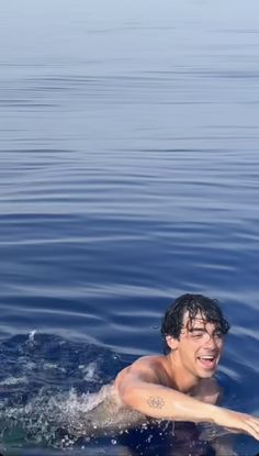 a man riding on top of a surfboard in the ocean