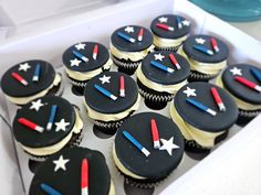 cupcakes in a box decorated with stars and arrows