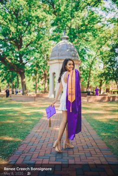 a woman in a graduation gown and purple stole