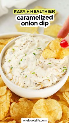 a hand dipping chips into a bowl of dip with the words easy healthier caramelized onion dip