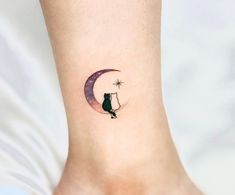 a small cat sitting on the moon tattoo