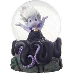 Dressed as Ursula from Disney’s The Little Mermaid, this underwater mischief-maker has arms outstretched triumphantly as she stands upon the rocks. This musical snow globe plays “Moonlight Sonata”. What better way to show someone they leave you speechless than with a gift in honor of the sea witch who quite literally took Ariel’s voice! Perhaps it’s in the locket this little lady wears upon her neck. Fans of The Little Mermaid, as well as Disney Villain collectible gifts in general, will enjoy t Disney Precious Moments, The Sea Witch, Snow Globe Crafts, Mermaid Figurine, Musical Snow Globes, Moonlight Sonata, Disney Villain, Mermaid Decor, Sea Witch