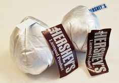 there are two silver balls with tags on them that say hershey's and the other one is white