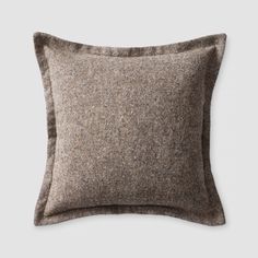 a brown and black pillow on a white background