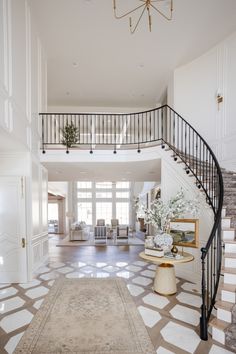 a large foyer with a staircase leading up to the second floor