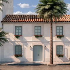 a white house with two palm trees in front of it and a car parked on the street