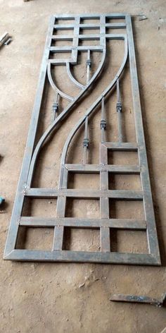 an iron door frame laying on the ground