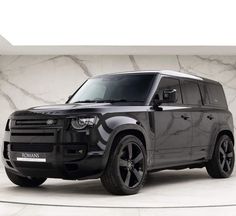 a black suv parked in front of a marble wall