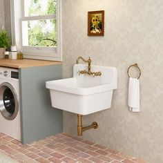 a washer and dryer in a bathroom with brick flooring on the walls