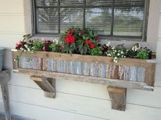 an old window sill has flowers in it and is attached to the outside wall