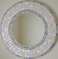 a white and blue circular mirror hanging on the wall