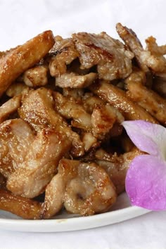 a plate full of fried chicken with a flower on the side