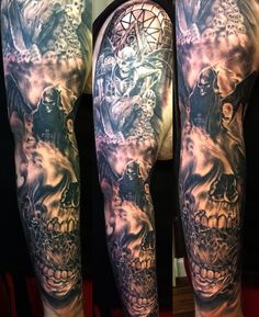 a man's full sleeve with skulls and other tattoos on his arm, in black and grey