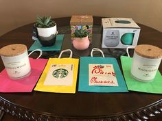 there are many starbucks bags on the table