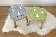 two children's stools sitting on top of a white rug